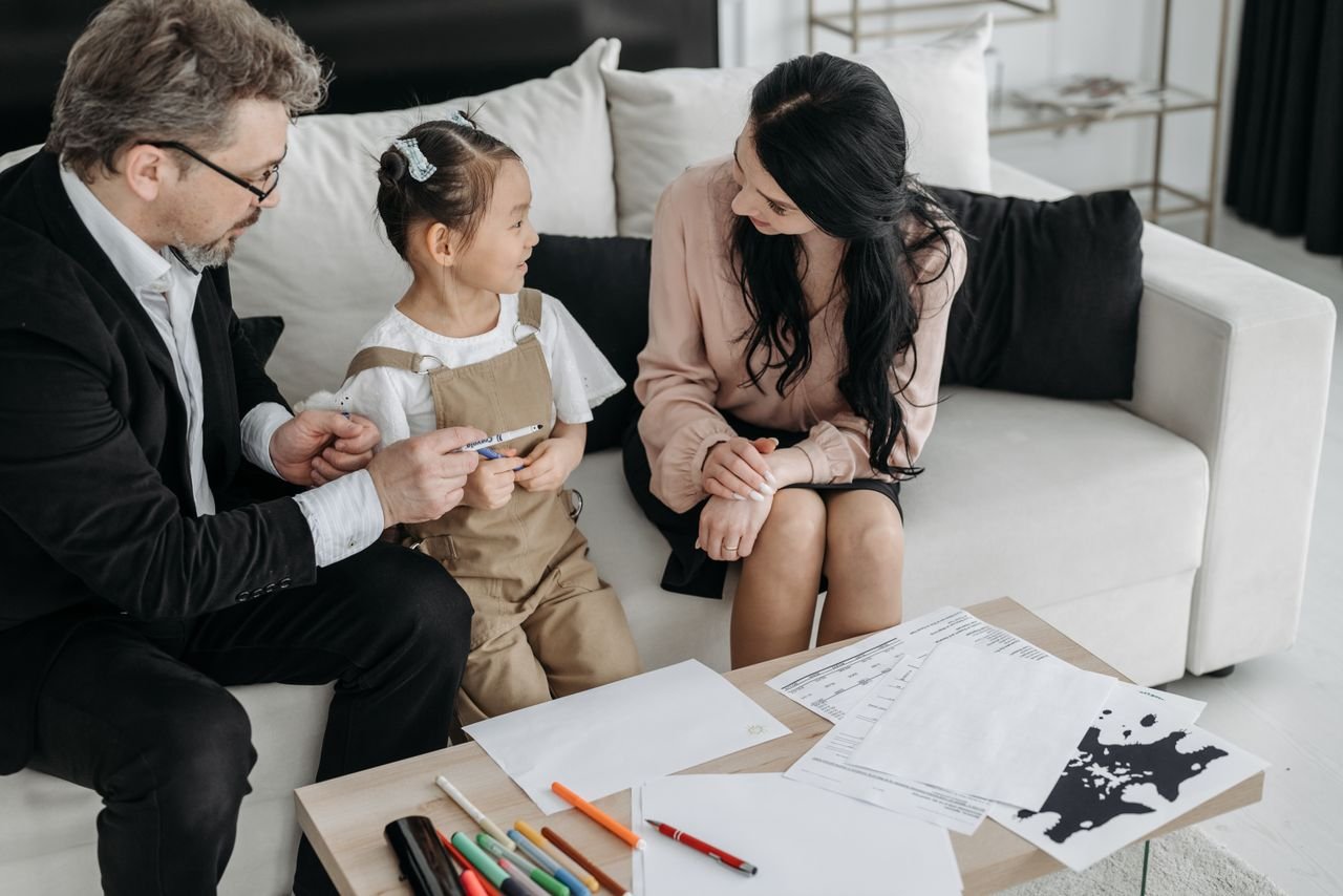 A family chatting happily on a living room couch, fostering togetherness and love.